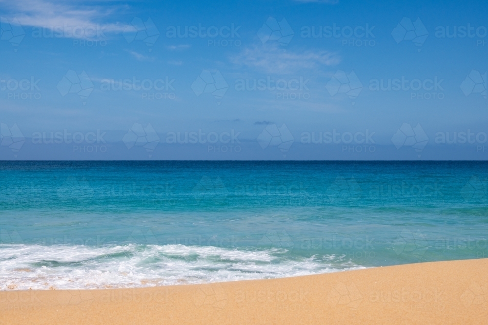 Landscape view of sand and ocean, and blue sky - Australian Stock Image