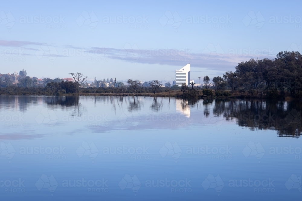 landscape view over inlet to Bunbury city with high rise building dominating the horizon - Australian Stock Image