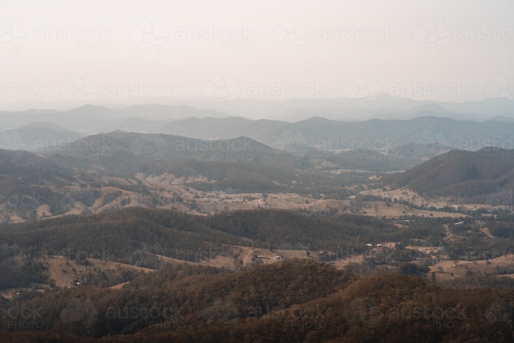 Landscape with hazy mountain views behind a valley in regional New South Wales. : Austockphoto Landscape with hazy mountain views behind a valley in regional New South Wales. - Australian Stock Image