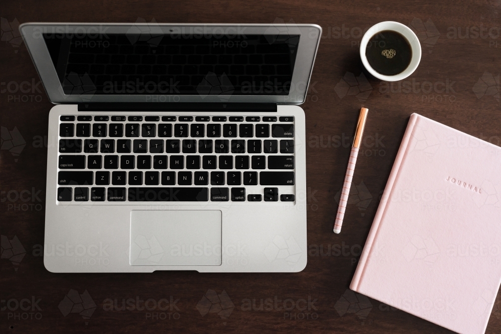 laptop with journal and coffee - Australian Stock Image