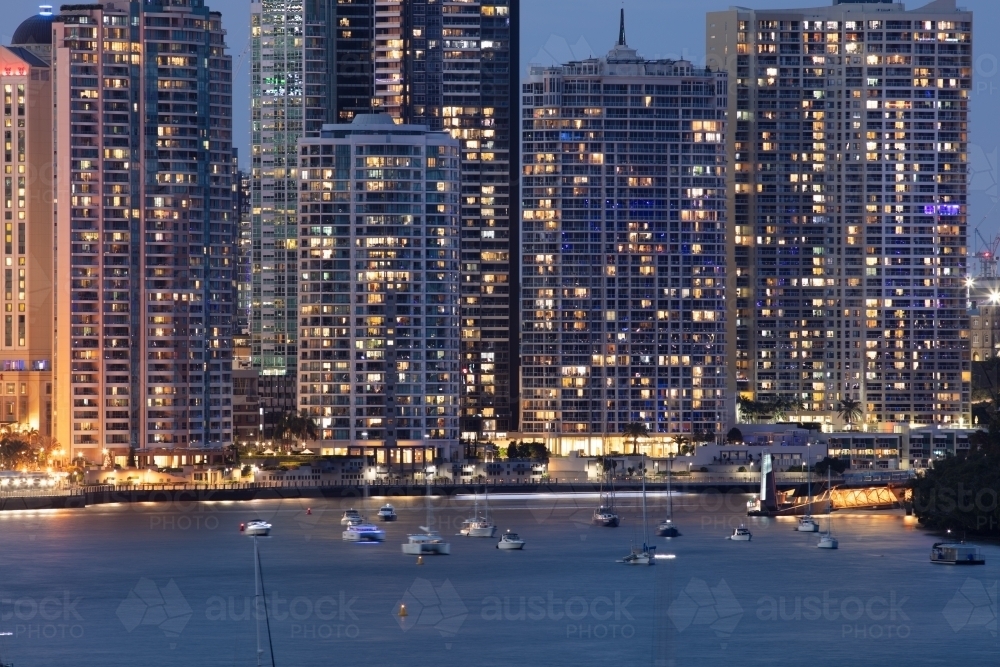 Large apartments buildings alongside the Brisbane River during the evening - Australian Stock Image