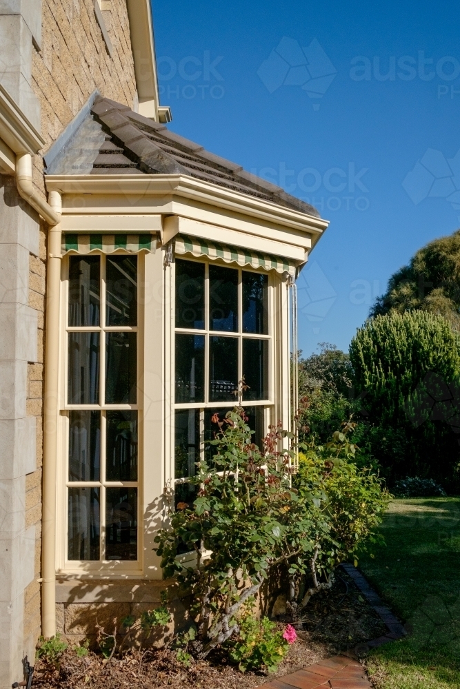 Image of Large bay window with garden outside Austockphoto