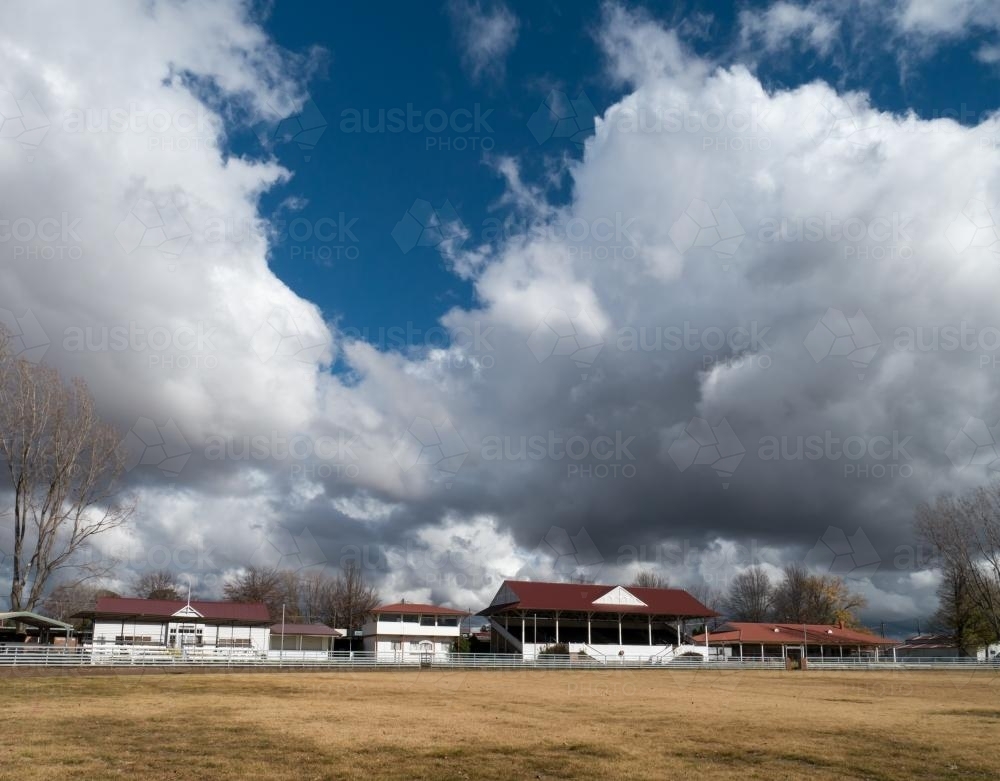 Large billowing clouds over the Glen Innes showground pavilion - Australian Stock Image