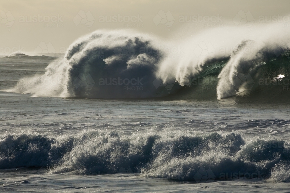 Large breaking wave blown back by the wind - Australian Stock Image