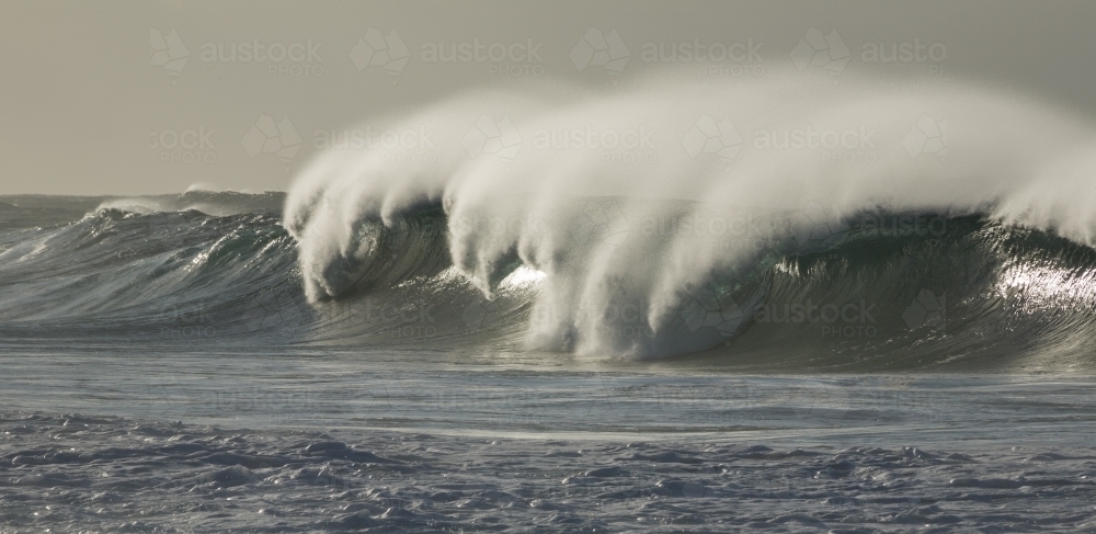 Large breaking wave with 'white horses' and blowback - Australian Stock Image