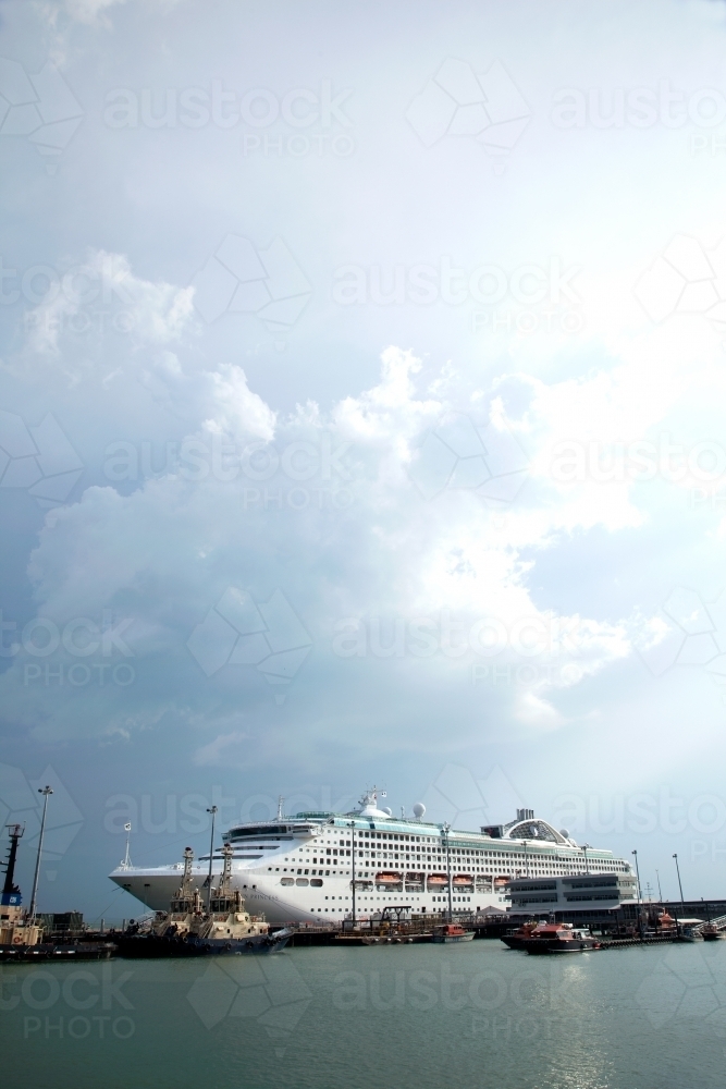 Large cruise liner docked at an industrial port - Australian Stock Image
