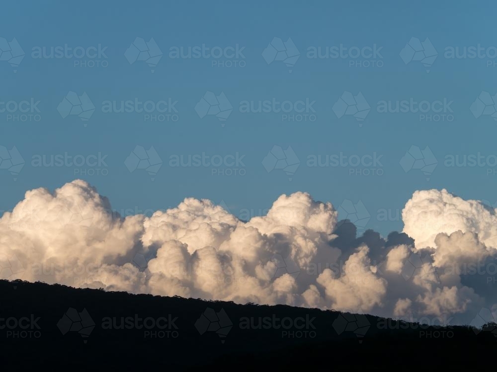Large cumulus clouds with blue sky above - Australian Stock Image