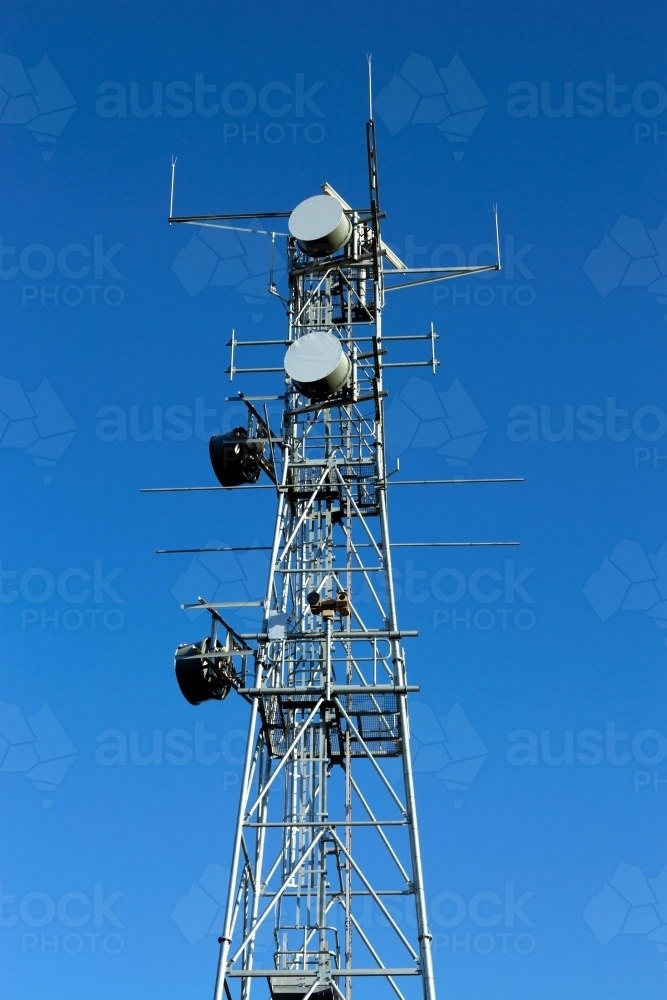 Large industrial telecommunication tower with blue sky behind - Australian Stock Image