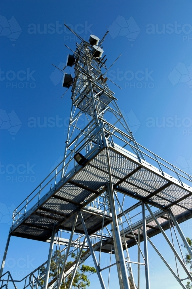 Large industrial telecommunication tower with blue sky behind - Australian Stock Image
