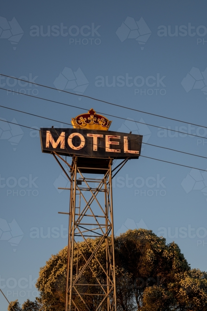 Large light-up 'MOTEL' sign against blue sky - Australian Stock Image