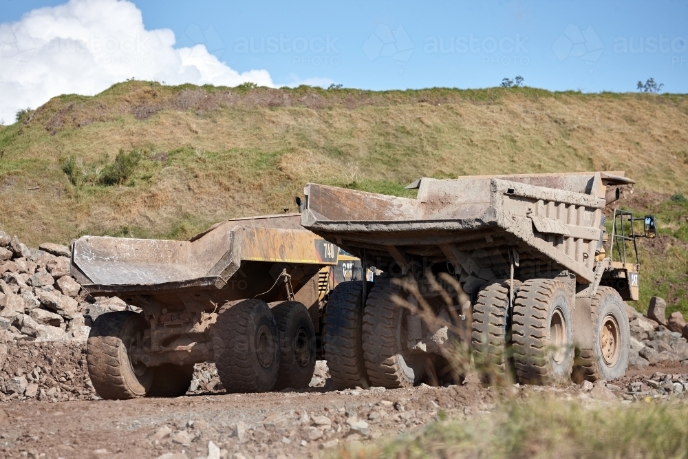 Large mining trucks parked at quarry - Australian Stock Image