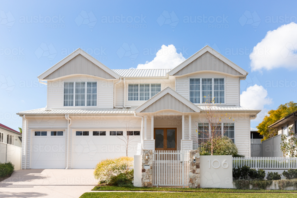 large new home with white walls and roof in Brisbane with blue sky - Australian Stock Image