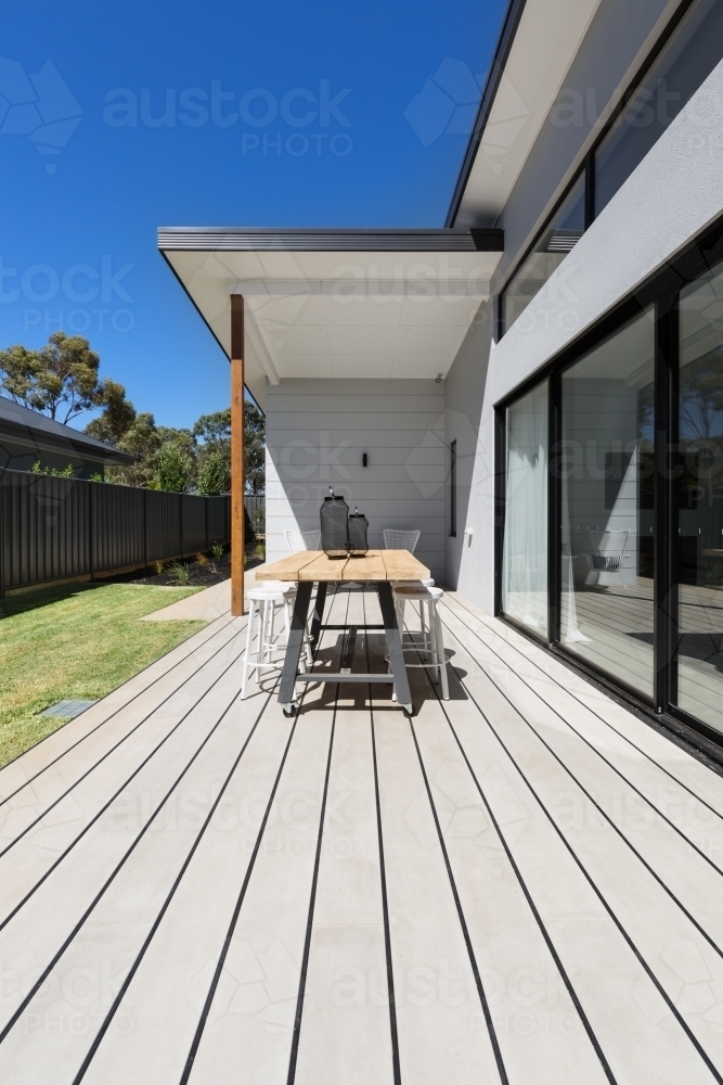 Large outdoor decking and high entertaining  table in a new home - Australian Stock Image