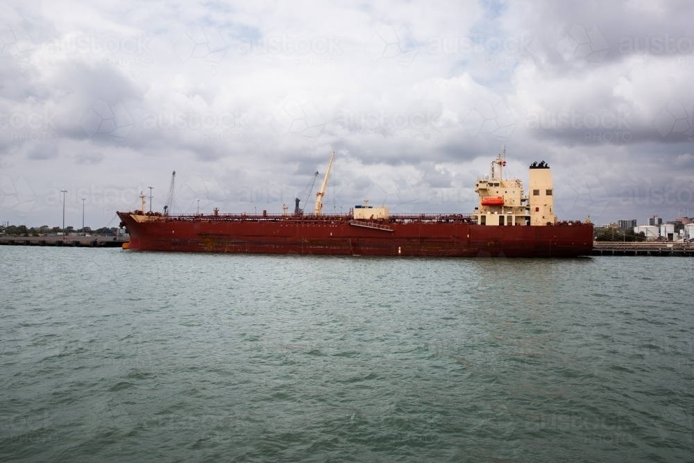 large ship docked in Gladstone Harbour on cloudy day - Australian Stock Image