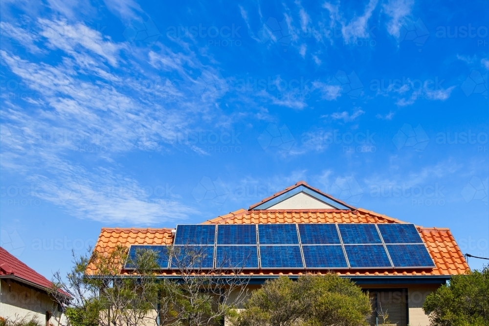 Large solar panels on suburban rooftop - Australian Stock Image