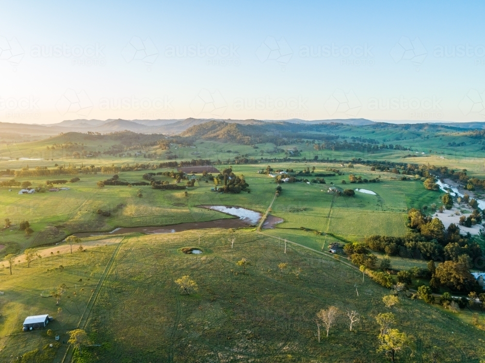 Last light of the day over farmland with dam beside Hunter River in Aberglasslyn Maitland - Australian Stock Image