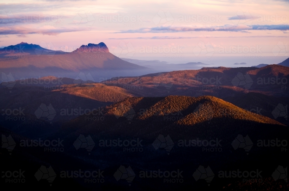 Last light touching the mountain ranges - Australian Stock Image