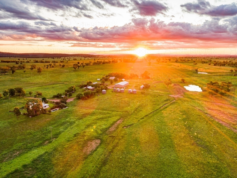 Last rays of sunlight over farmland and dam - Australian Stock Image