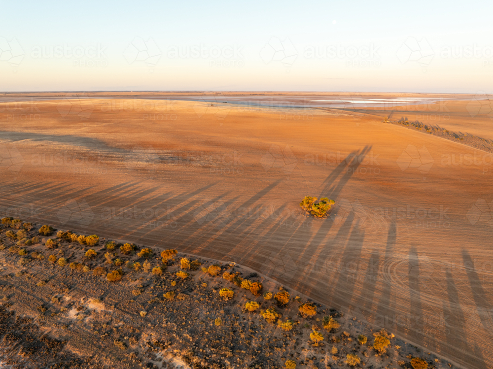 Late afternoon light and long shadows over farmland - Australian Stock Image
