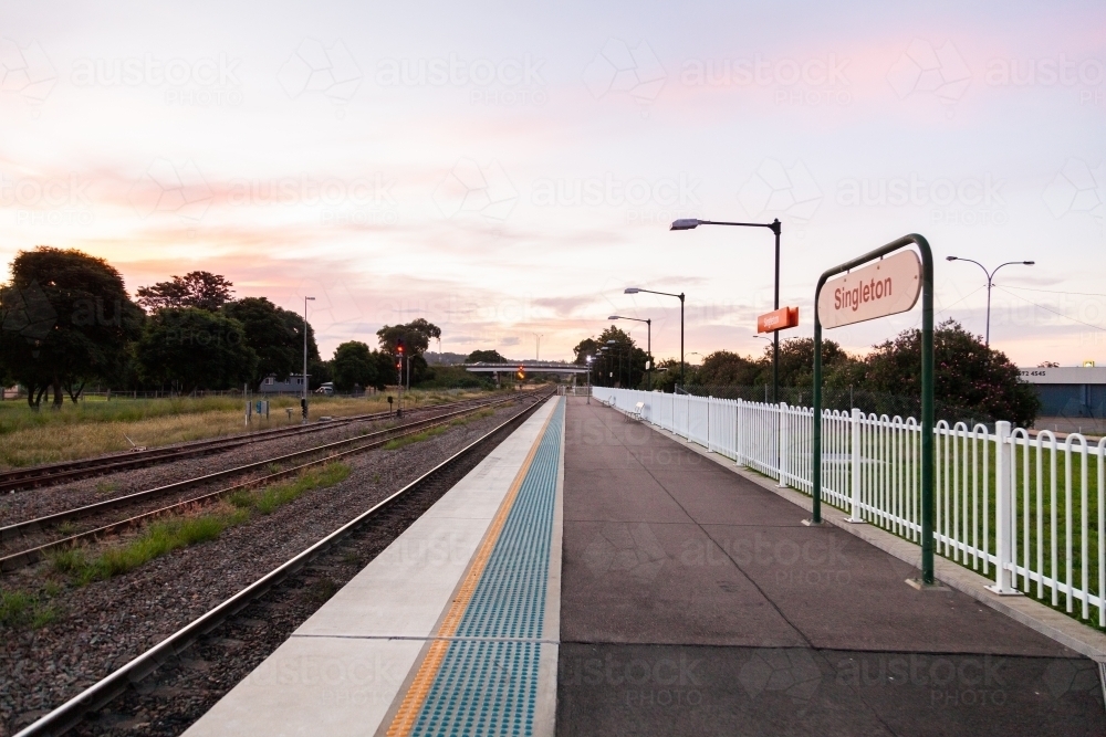 Late or early light over long empty train station platform in Singleton - Australian Stock Image