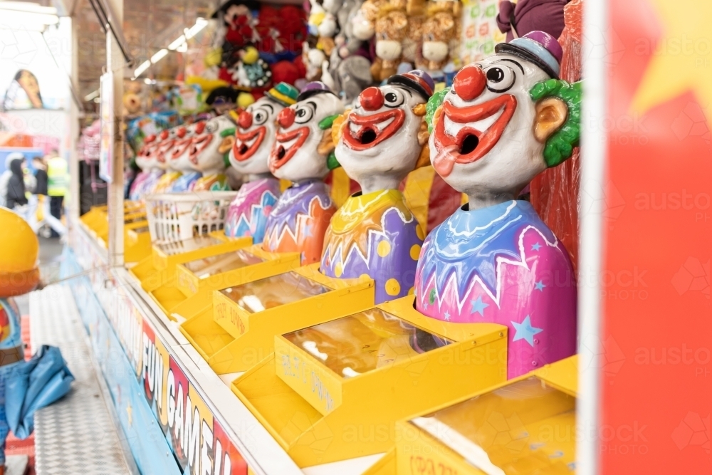 Laughing clowns game attraction at a fair carnival - Australian Stock Image