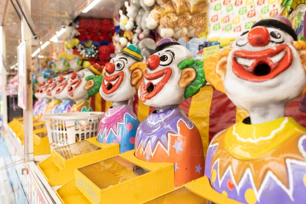 Laughing clowns game attraction at a fair carnival - Australian Stock Image