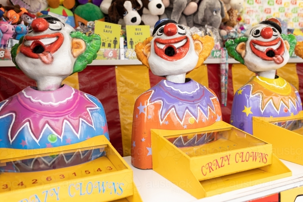 Laughing clowns game attraction at a fair carnival - Australian Stock Image