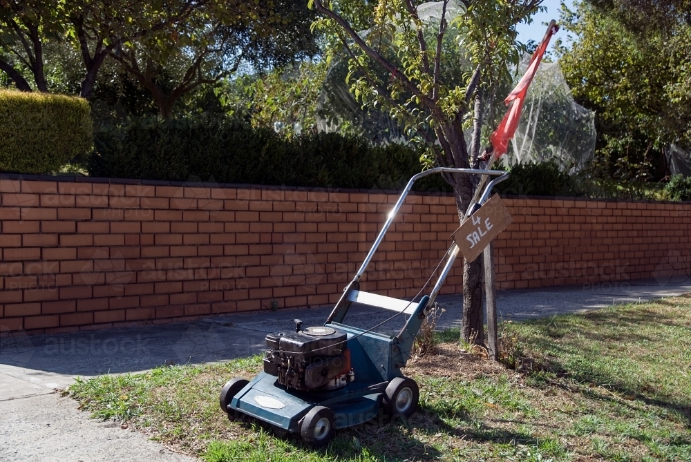 Lawnmower for sale on the nature strip - Australian Stock Image