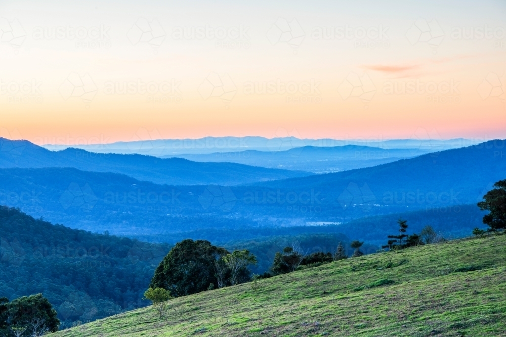 Layers of mountains at sunset looking over Gold Coast hinterland. - Australian Stock Image