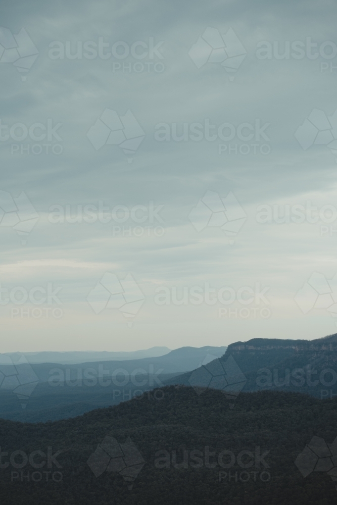 Layers of mountains into the distance during blue hour in the Blue Mountains. - Australian Stock Image