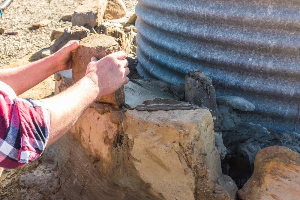 Image of Laying rocks to create a wall - Austockphoto