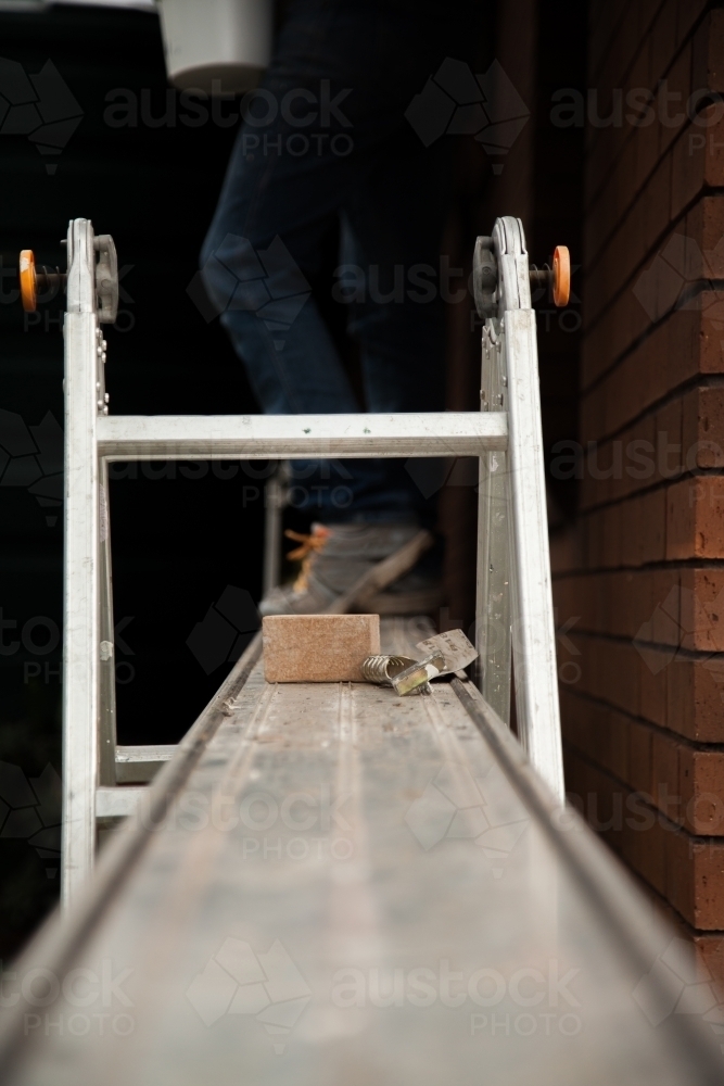 Leading lines of scaffolding plank to ladder - Australian Stock Image