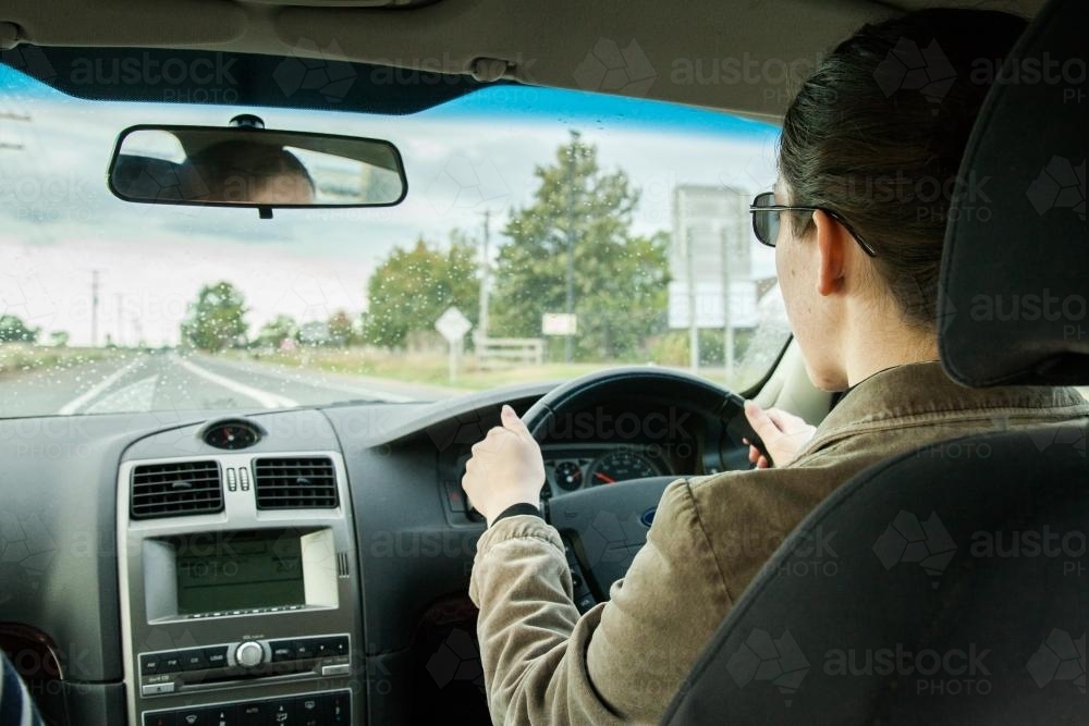 Learner driver getting rain driving experience - Australian Stock Image