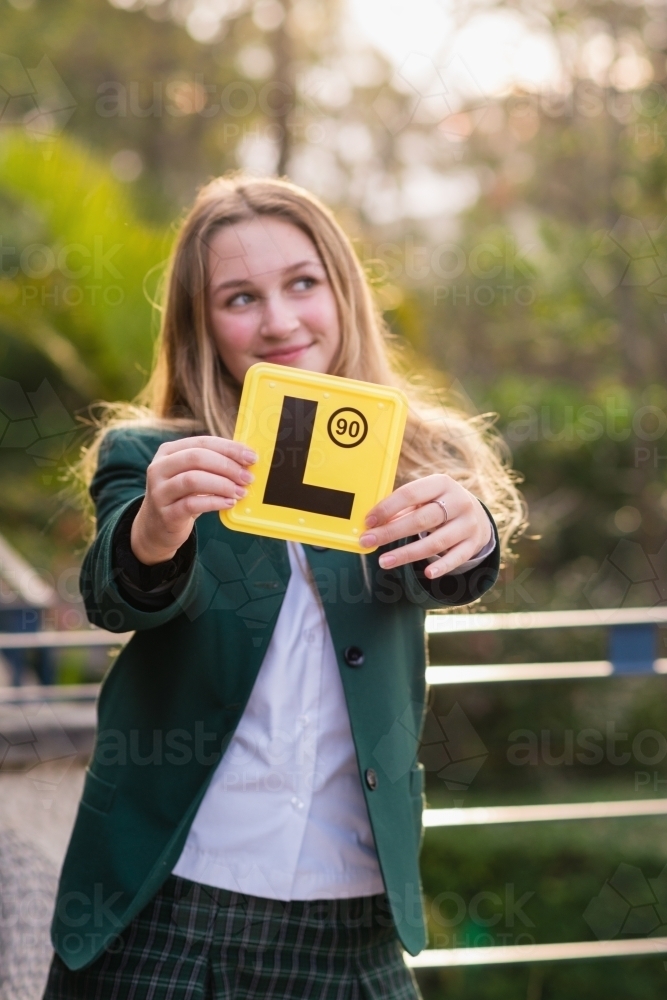 learner driver holding L plate - Australian Stock Image