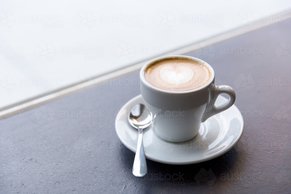 Leisurely latte coffee at cafe - Australian Stock Image