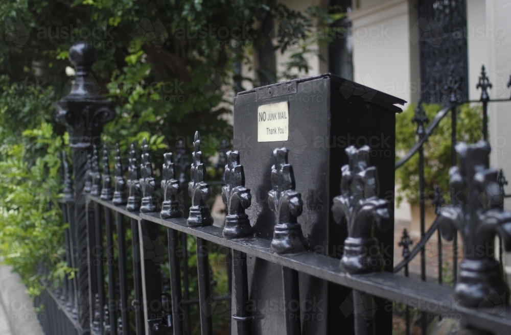 Letterbox and wrought iron fence outside terrace house - Australian Stock Image