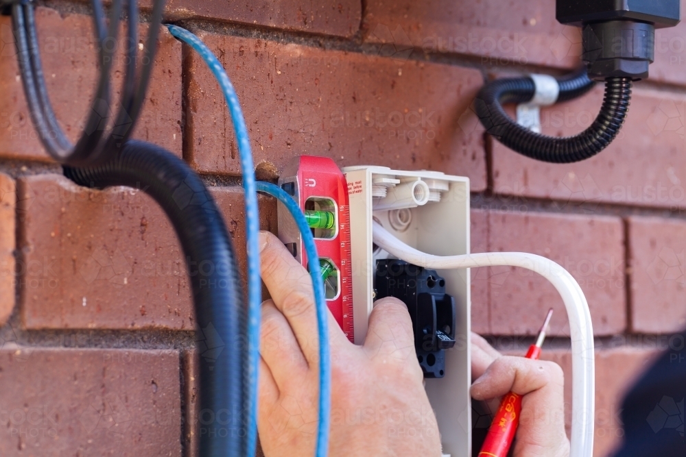 Image of Levelling a switch for solar power installation - electrician ...
