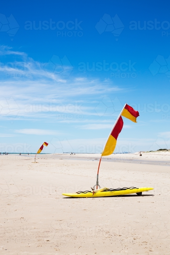 Life saver flags on the beach vertical - Australian Stock Image