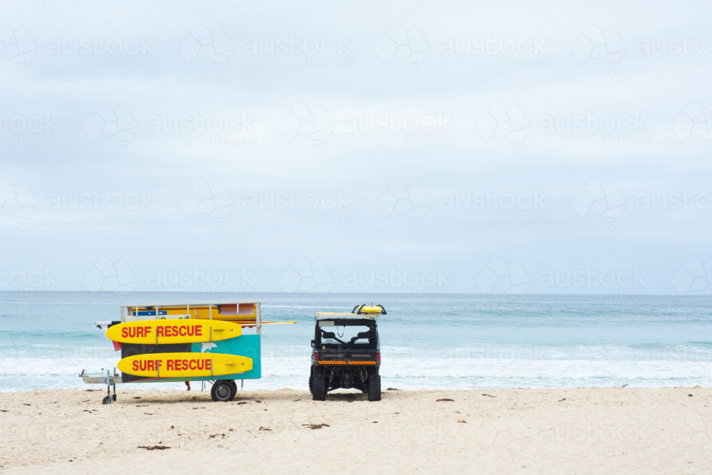 Life saving buggy and boards on the beach - Australian Stock Image