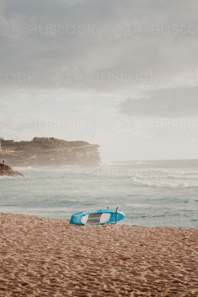 Lifeguard rescue board on the sand at Bronte Beach - Australian Stock Image