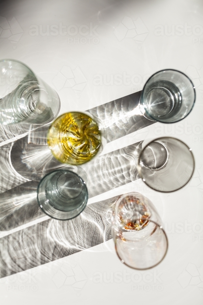 Light casting patterned shadows through colourful cup glasses - Australian Stock Image