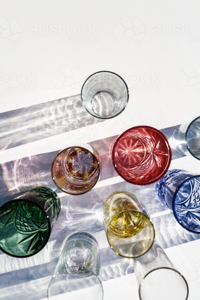 Light casting patterned shadows through colourful cup glasses - Australian Stock Image