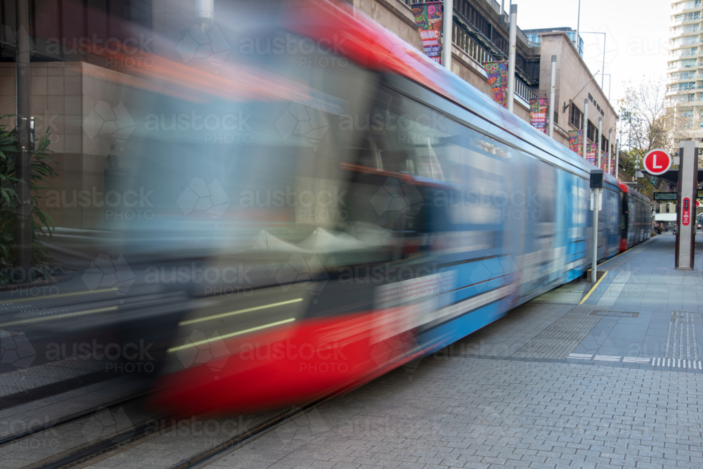 Light rail moving past at Circular Quay, Sydney shot with a long exposure - Australian Stock Image