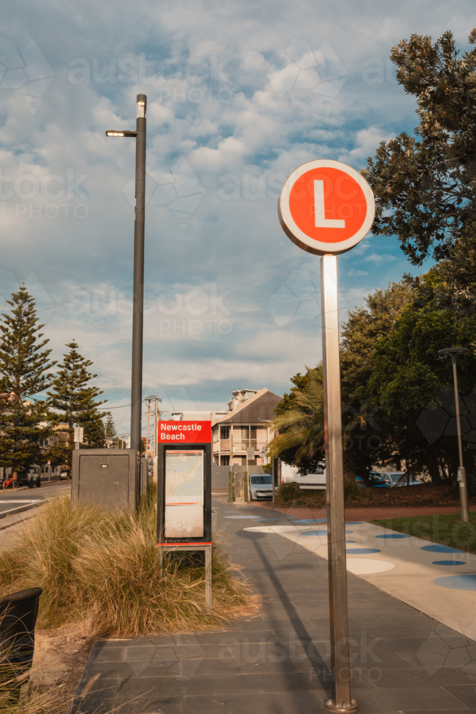 Light rail stop at Newcastle Beach with red L sign - Australian Stock Image