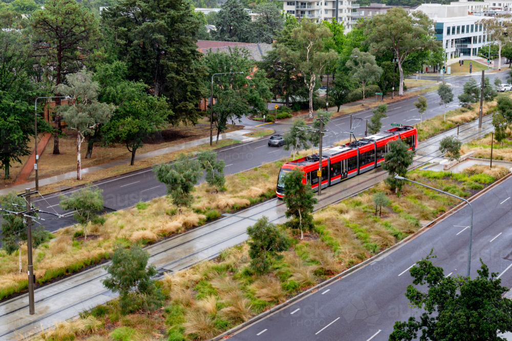 Image of light rail track in Canberra with a red train from above ...
