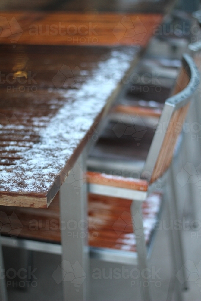 Light snow on timber furniture - Australian Stock Image