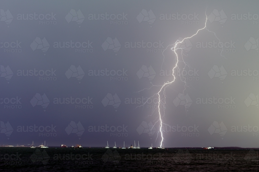 Lightning bolt over yachts in Darwin - Australian Stock Image