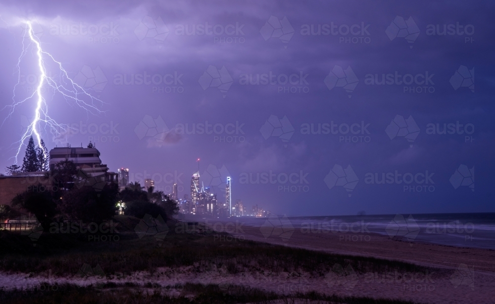 Lightning bolts across the night sky against the Gold Coast cityscape - Australian Stock Image