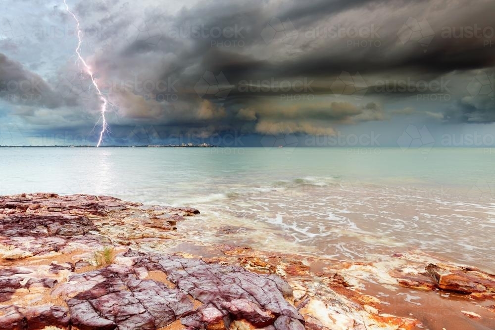 Lightning over Darwin city across the water - Australian Stock Image
