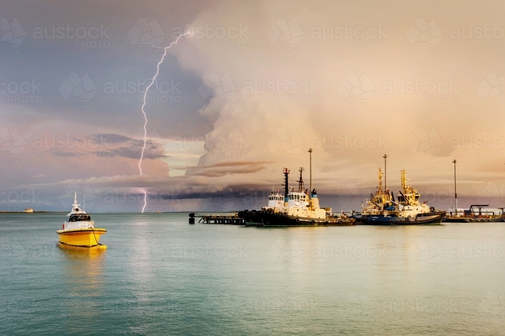 Lightning over Fort Hill Wharf and boats, in Darwin - Australian Stock Image